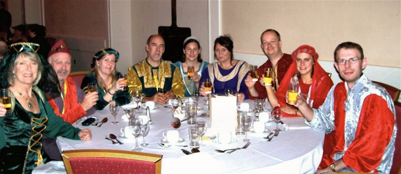 Picture of members making a toast in their Robin Hood dress.
