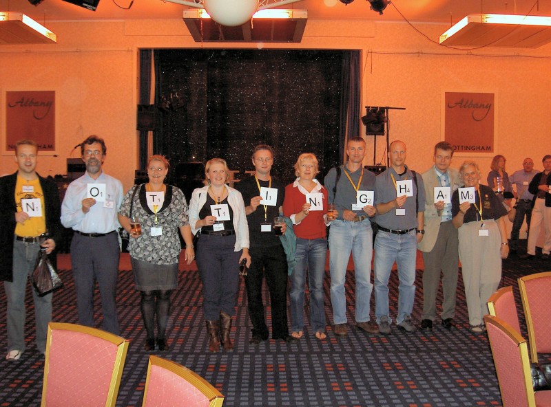 Picture of members holding oversize scrabble tiles spelling 'Nottingham'.