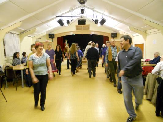 Photo of members participating in a barn dance.