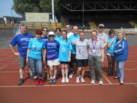 The relay for life team pose for a group photograph.