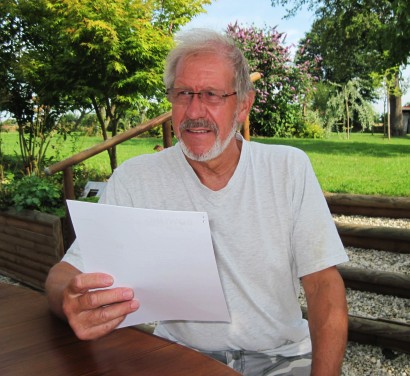 Toby Wren, sitting relaxed in a garden with a letter in his hand