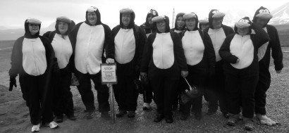The group, dressed in penguin costumes ashore in Ny Alesund