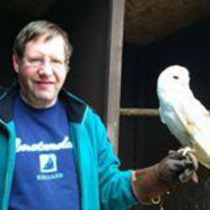 Photo of Alistair with a bird on his gloved hand