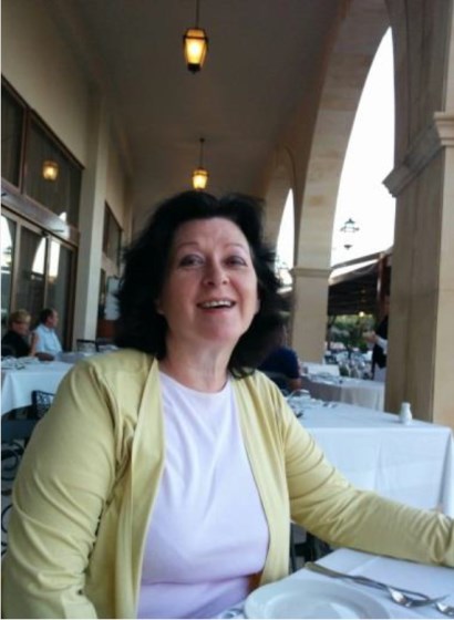 Andrea, stitting at table on a restaurant veranda