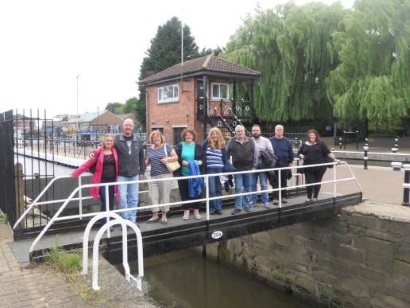 The group stand across a short bridge over a canal
