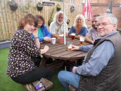 The group around a round pub garden table