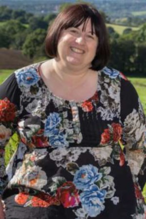 Gail, in the countyside, wearing a floral dress