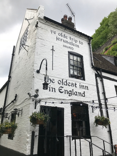 Whitewashed building with black lettering on the front saying 'ye olde trip to jerusalem', '1189AD' and 'the oldest inn in England'