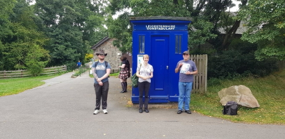 Members in front on a blue police box in Bradgate Park