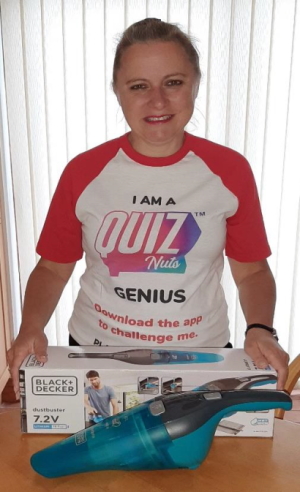 Maxine, wearing her 'I am a quiz nuts genius' t-shirt behind the dust buster prize