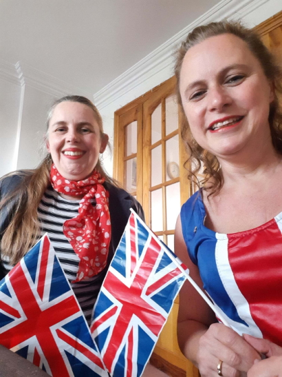 Maxine and her friend dressed in red, white an blue and holding union flags.