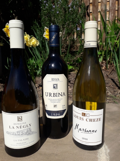Three wine bottles with labels showing 'Domaine La Negly', 'Urbina' and 'Louis Cheze Marianne'