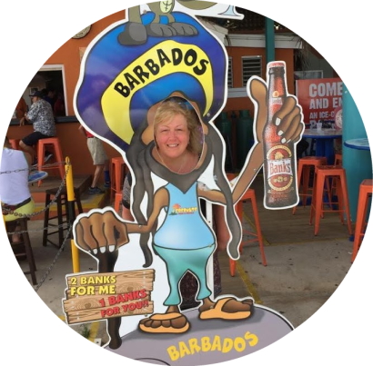 Carole puts head through an advertising board for Banks beer in Barbados