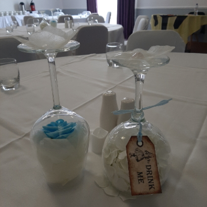 Upturned wine glasses on a white table-cloth covered table