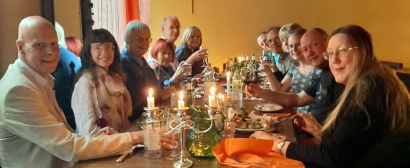 The group of about a dozen members sitting around a candle-lit table