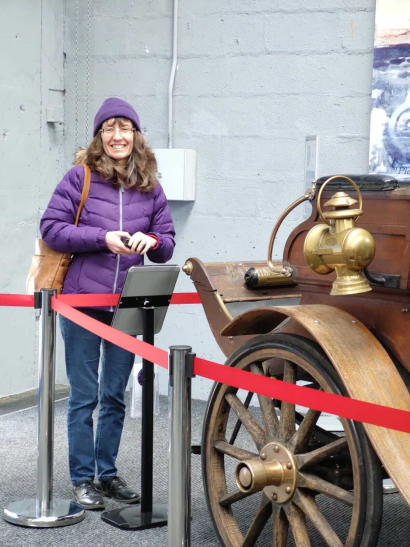 Susan stands in front of the Arrol-Johnston vintage motor.
