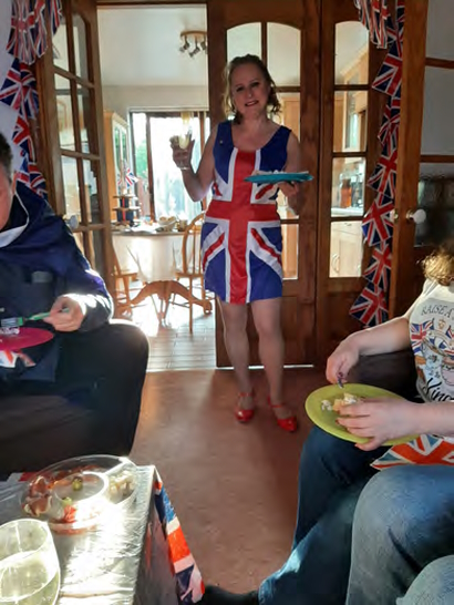 Maxine, at home, in a Union Jack dress