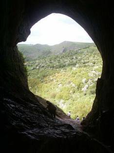 Picture from inside Thor's cave with the mouth of the cave in inverse silhouette.