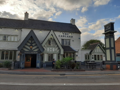 Front elevation of the Cadland showing a smart but traditional Pub in white and slate grey