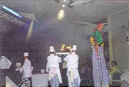 Picture of chefs grandly carrying in the food.