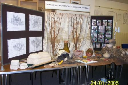 Picture of a display of archaeological material with the society banner as backdrop