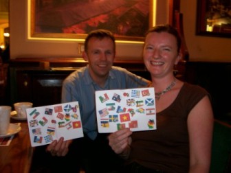 Picture of Sarah and Adrian Parkinson with their Globetrougher passports covered in stamps
