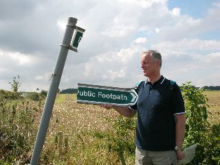 Picture of a public footpath sign split in two
