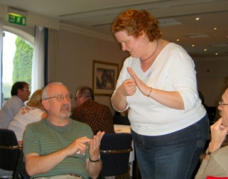 Picture of two of the group trying some more sign language