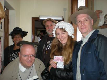 Five members pose in headgear from the Museum of Lincolnshire Life.