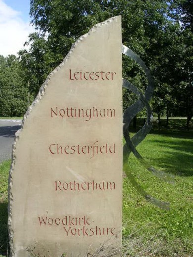Stony-Stratford signpost listing Leicester, Nottingham, Chesterfield, Rotherham and Woodkirk.