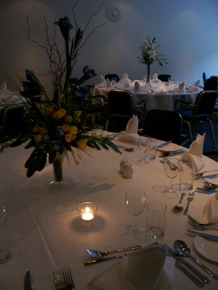 The dining room was set elegantly set out with table candles lighting up the centre piece flower decorations and silverware.
